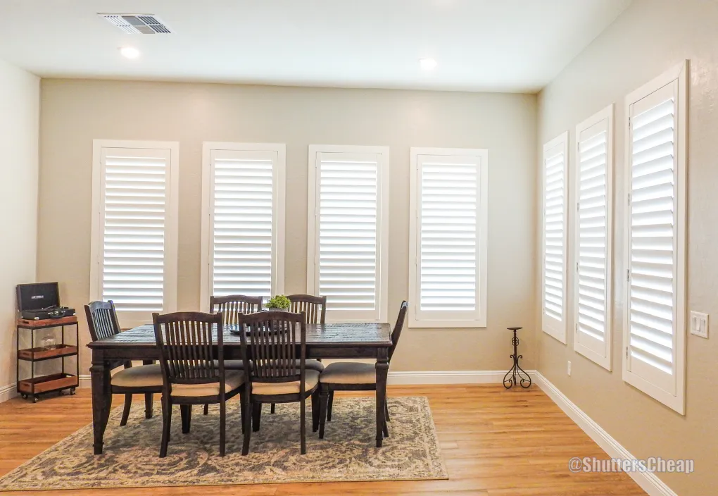 Kitchen with basswood shutters and roller shades